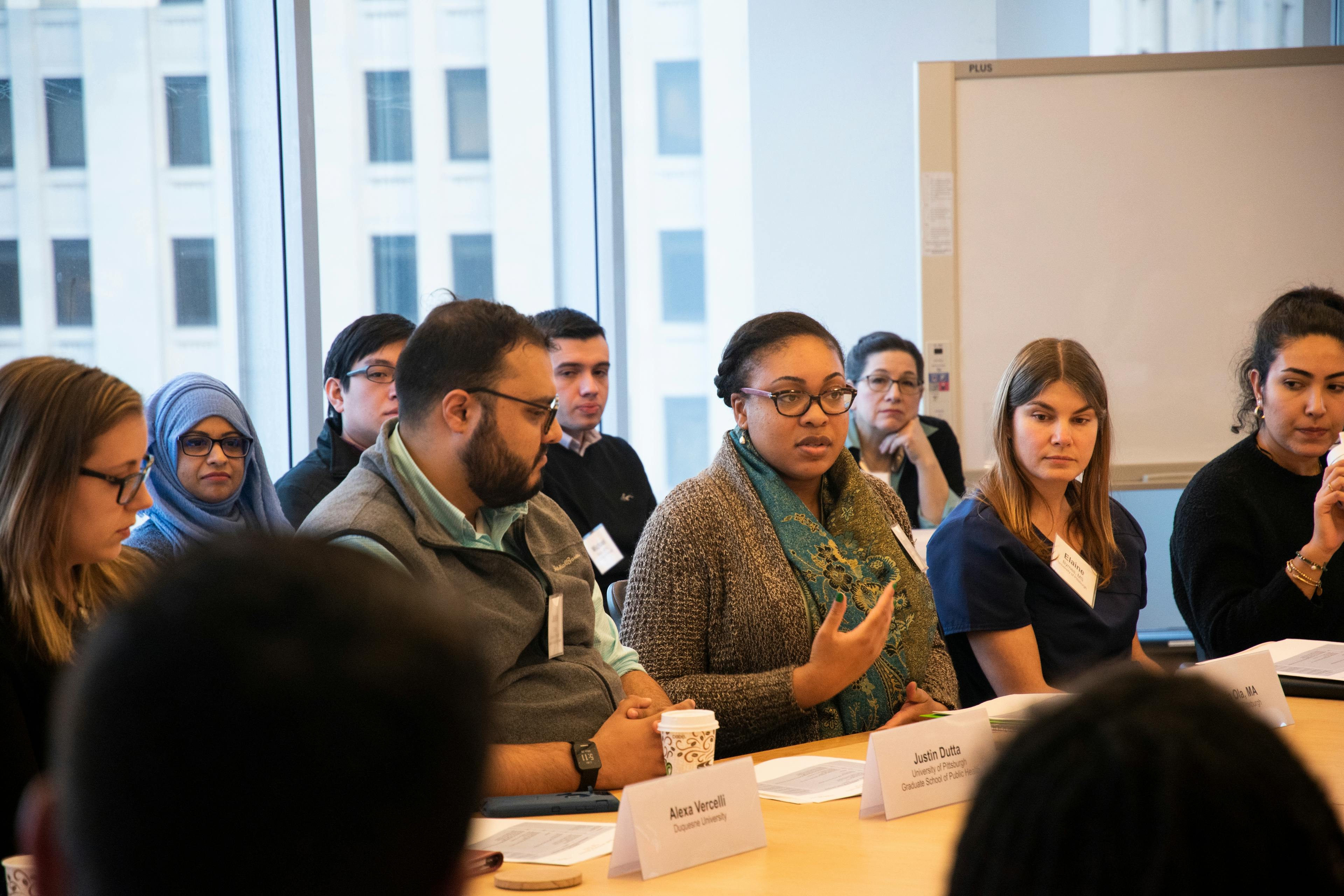 Fellowship participants share their perspectives during an in-person session.