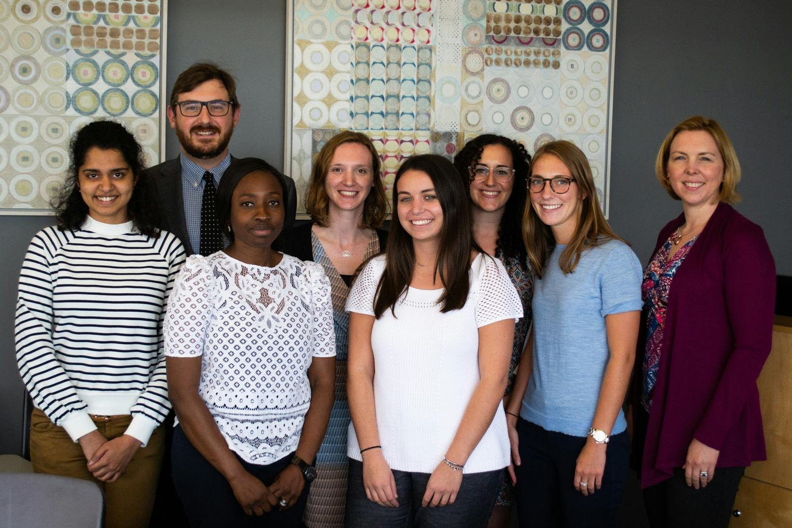 A group of interns poses for a photo.